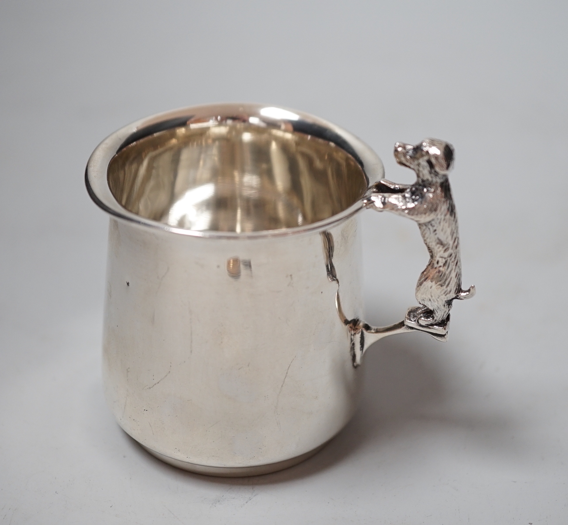A George V silver christening mug, with dog handle, Sanders & Mackenzie, Birmingham, 1931, 77mm, together with a lady's 9ct gold Vertex manual wind wrist watch, no strap and a Lorus nurses watch.